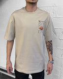 Oversized beige t-shirt with arrow back print and little teddy bear on World Richest Man currency note