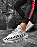 Zapatilla deportiva de hombre de moda en tejido de lona de punto en blanco y negro.