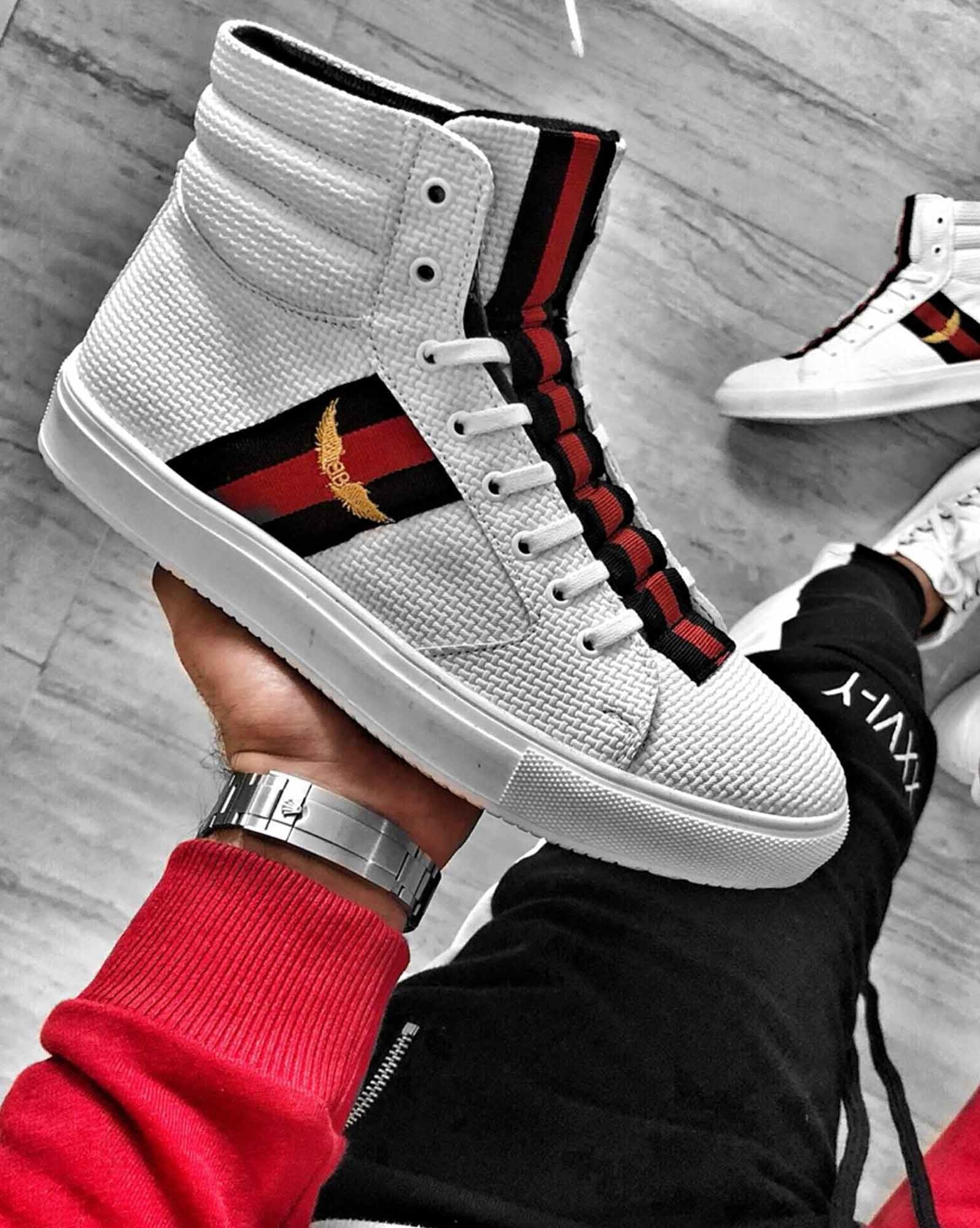 White high top sneakers with red black stripes