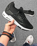 Black sneaker shoe with white air bubble effect sole