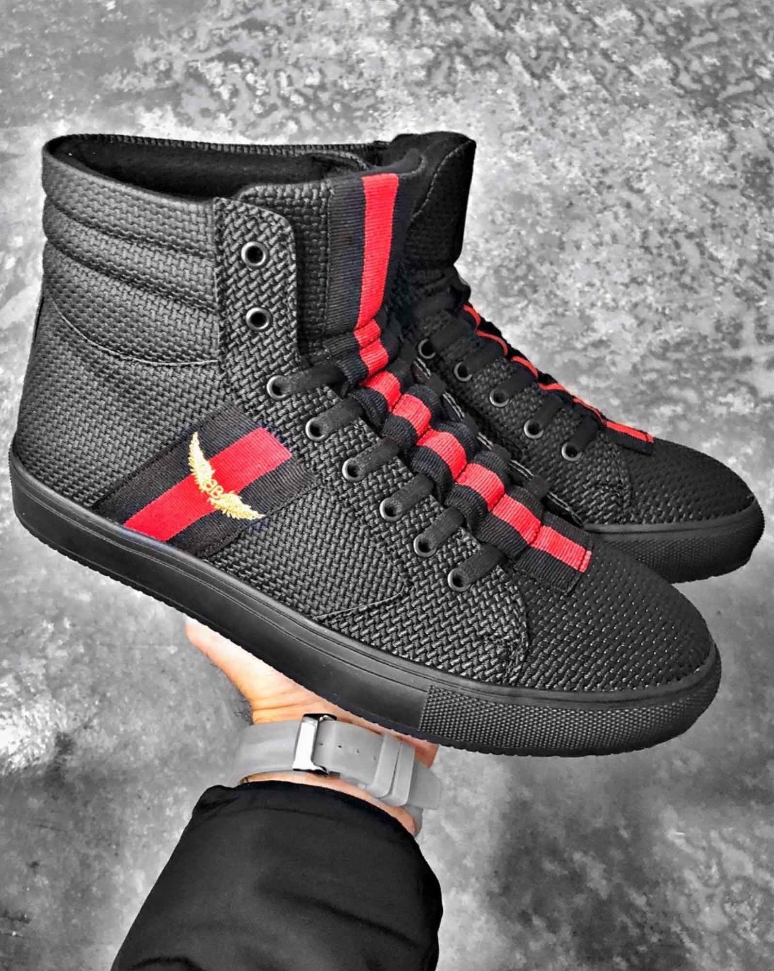 Black high-top sneakers with red black stripes on the front and side