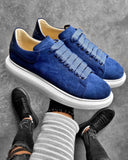 Pair of blue suede sneakers with white rubber sole