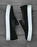 Black studded shoes and white loafer-type sole with black elastic suede look