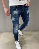 Distressed faded blue slim jeans with destroyed paint stains icon effect for men