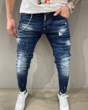 Distressed faded blue slim jeans with destroyed paint stains icon effect for men